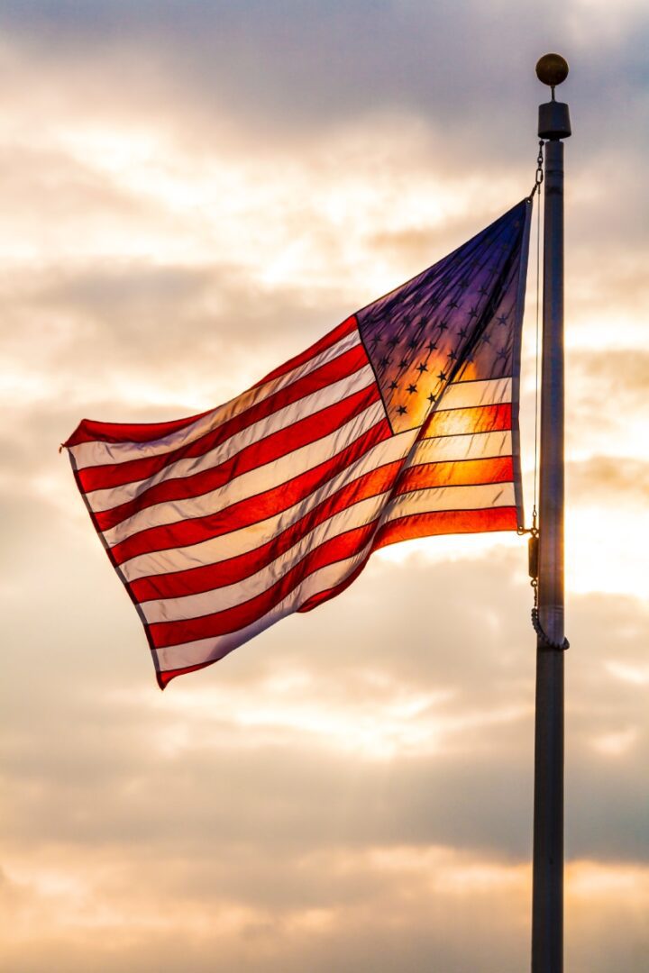 American flag sunset, waving proudly.