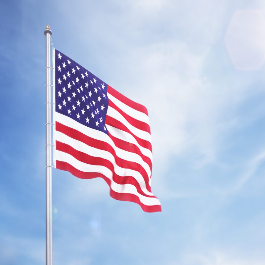 American flag waving in blue sky.