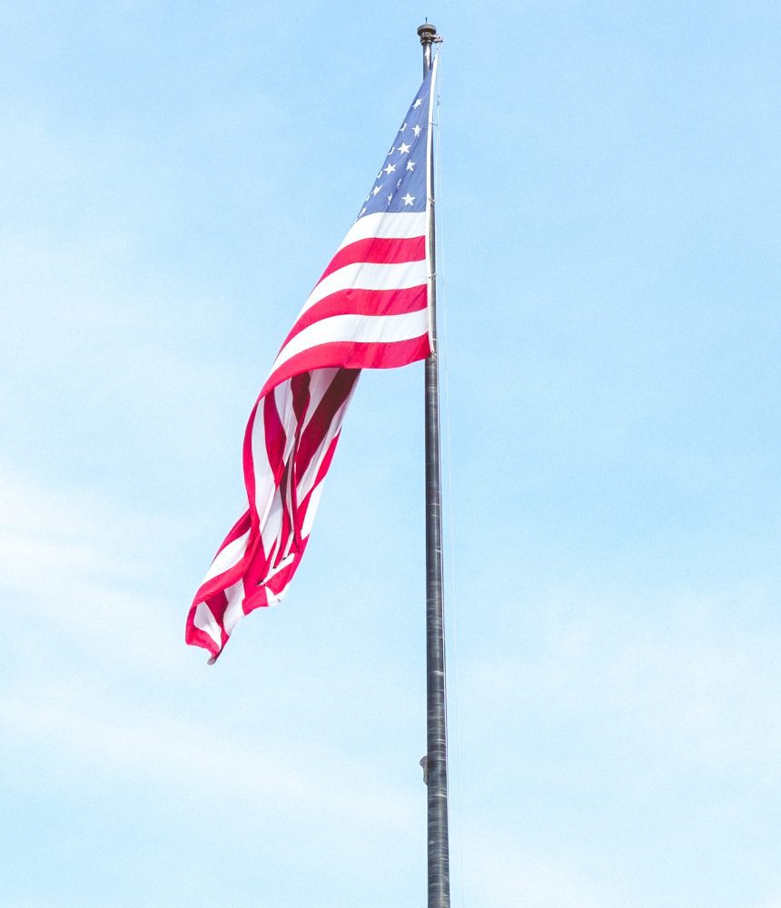 American flag waving on a pole.